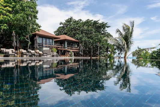 Sama Yoga House 300-Hour Yoga Teacher Training in Ko Samui, Thailand, offering breathtaking cliffside ocean views and various rooming options for a serene yoga retreat experience